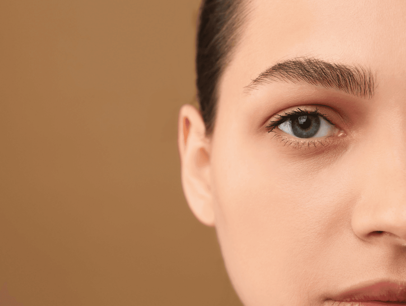 Client receiving a professional eyebrow maintenance wax to tidy stray hairs under the brow at a Weymouth beauty salon