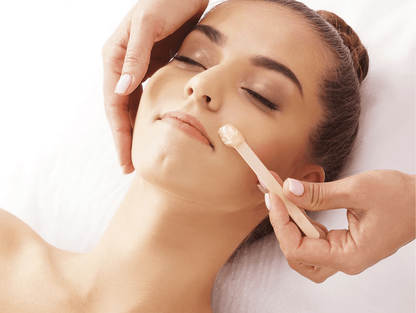 Client receiving eyebrow and upper lip wax treatment for smooth skin and defined brows in a professional Weymouth beauty salon