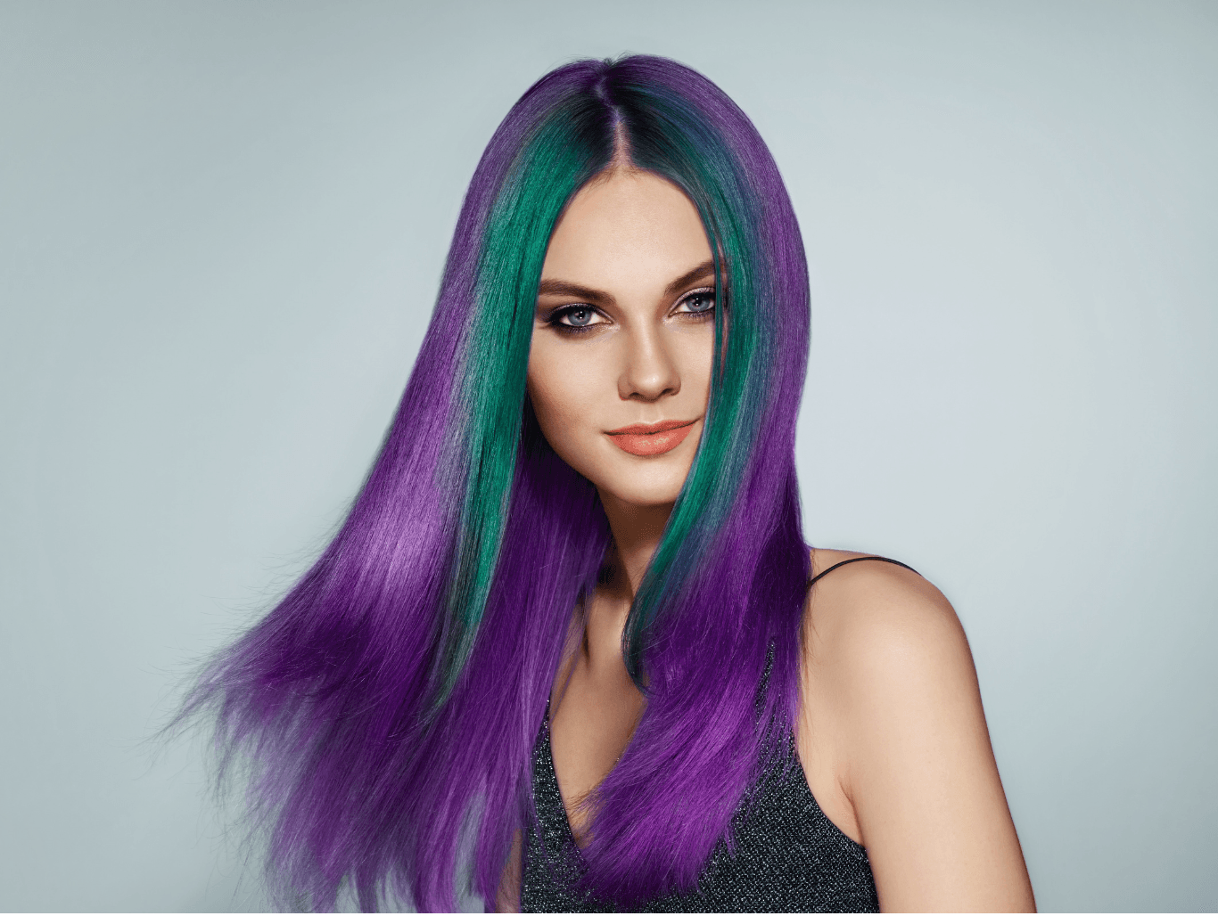 Model with vibrant purple and green flash panel colour showcasing bold, fashion-forward hair from a Weymouth salon
