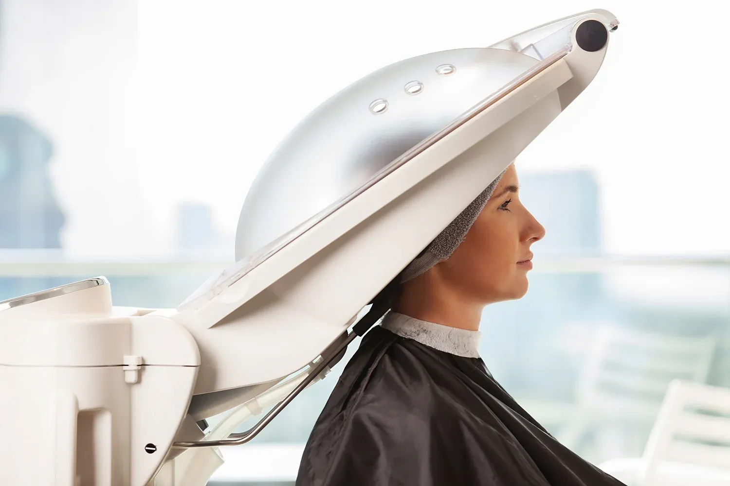 Woman receiving micro-mist steam hair spa treatment at Changing Grooms salon in Weymouth for deep conditioning and shine restoration.