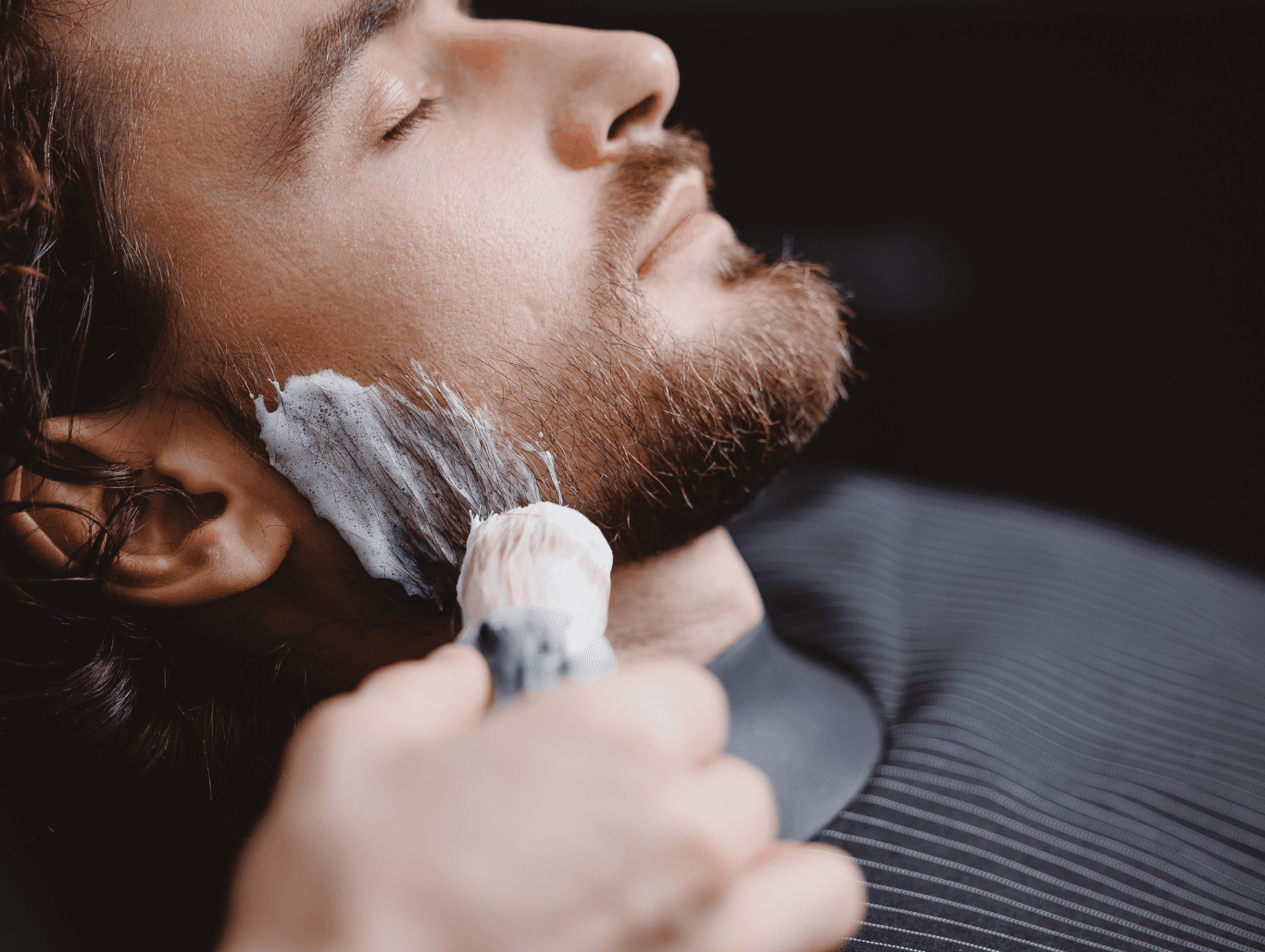 Man receiving luxury traditional shave with shaving brush and foam, part of a full grooming service at a Weymouth barbershop