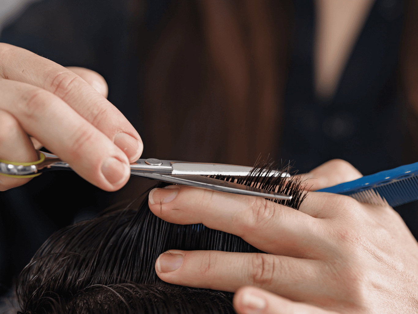 Close-up of a barber using scissors for a precise men’s haircut following a professional shampoo at a Weymouth salon