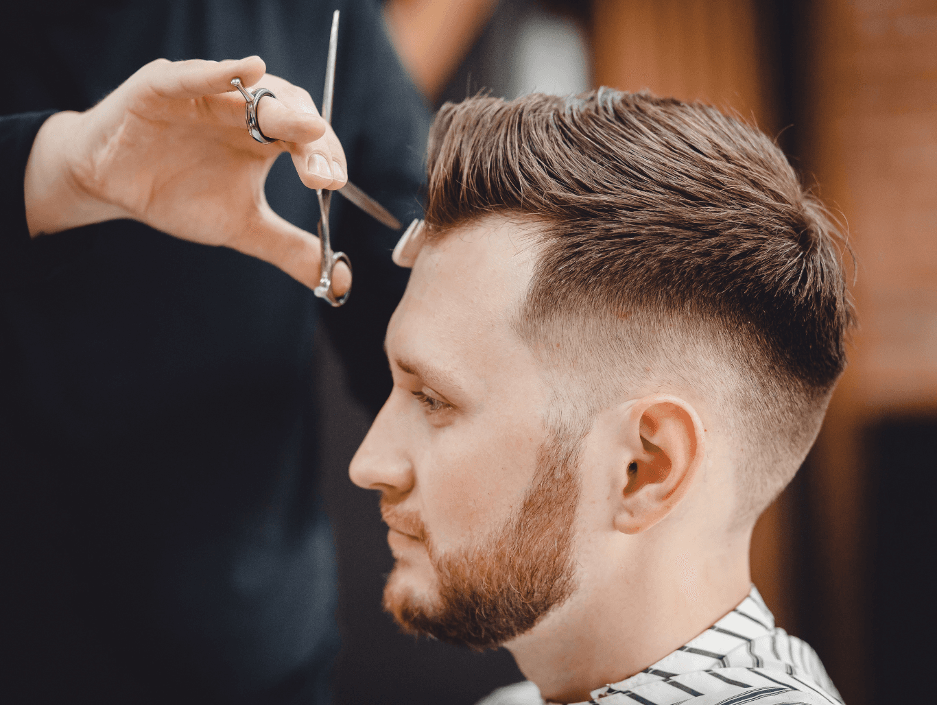 Man receiving a professional scissor restyle after a shampoo at a Weymouth barbershop