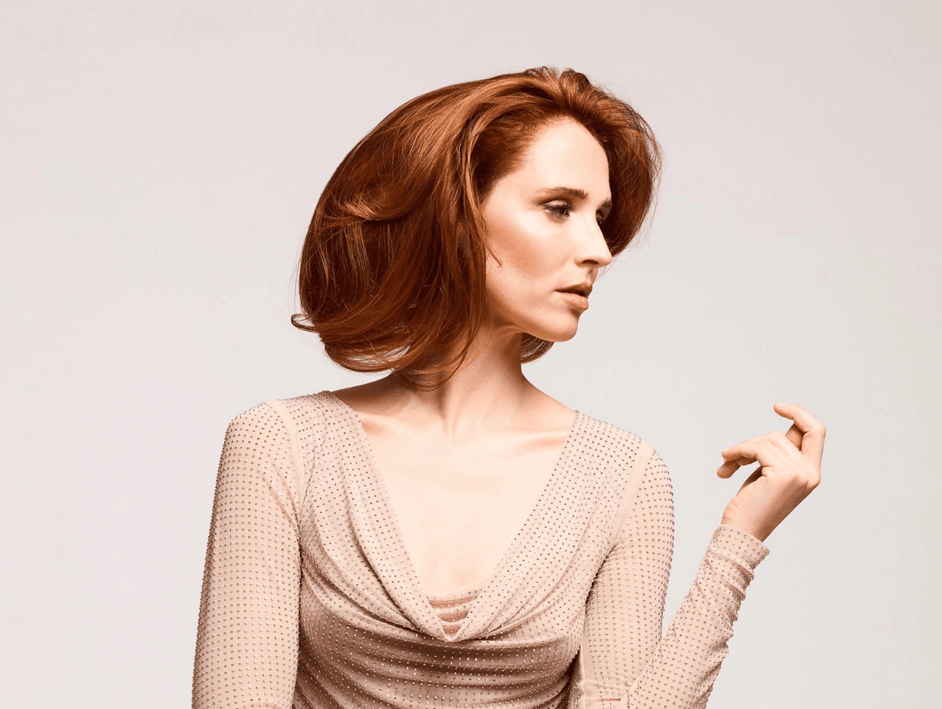 Model with rich copper hair colour, evenly toned from root to ends after a professional root tint and refresh service