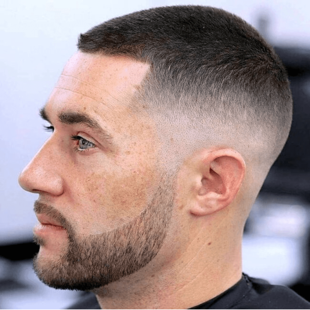 Clean foil-shaved skin fade with defined beard edge, including shampoo, scalp massage, and tonic at a Weymouth barber
